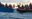 Scene of a rescue operation with the RHIB of SOS Humanity on the rights side and a refugee boat on the left side. One crew member is leaning over to the other boat to hand over life jackets.