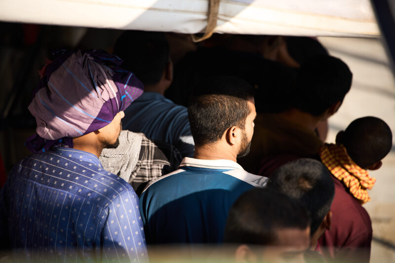 survivors on board Humanity 1, light in there faces and colourful clothes.