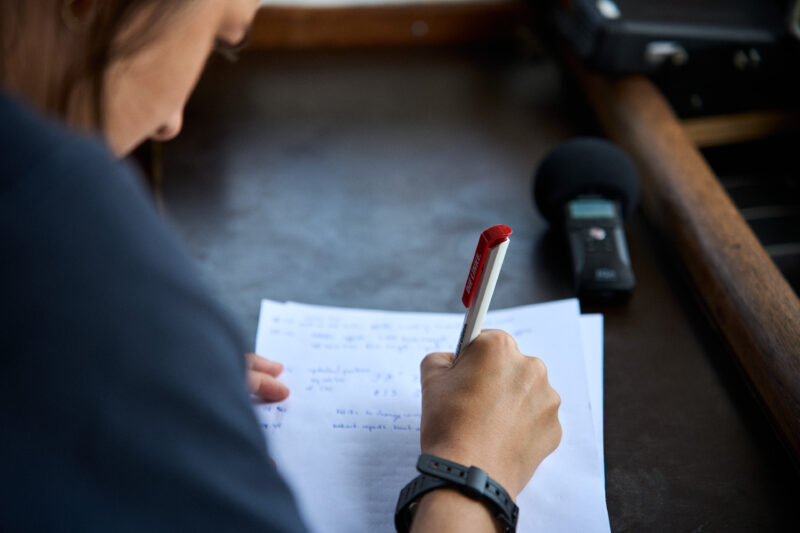 A crew member of SOS Humanity is writing a letter on board Humanity 1
