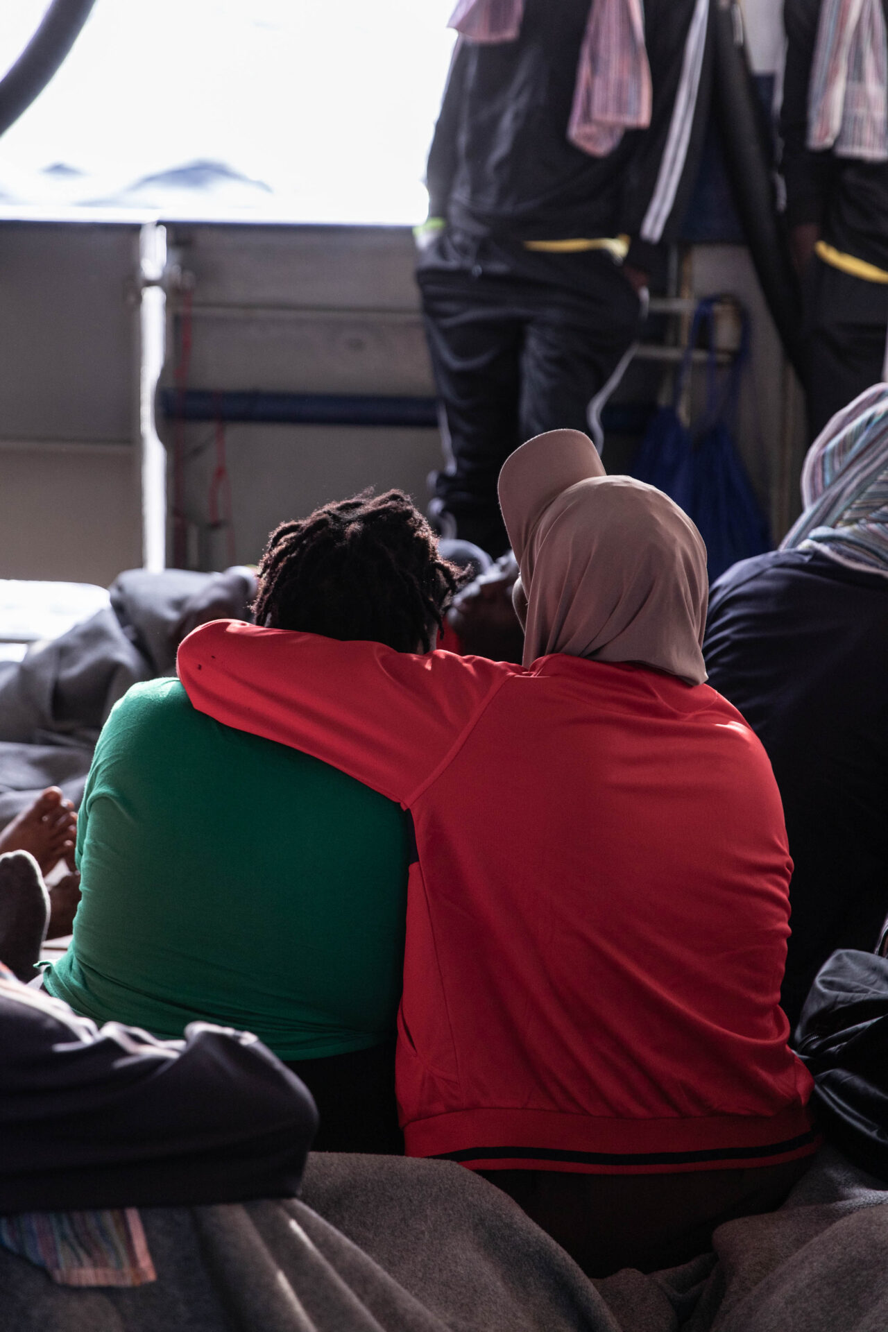 Two female survivors arm in arm.